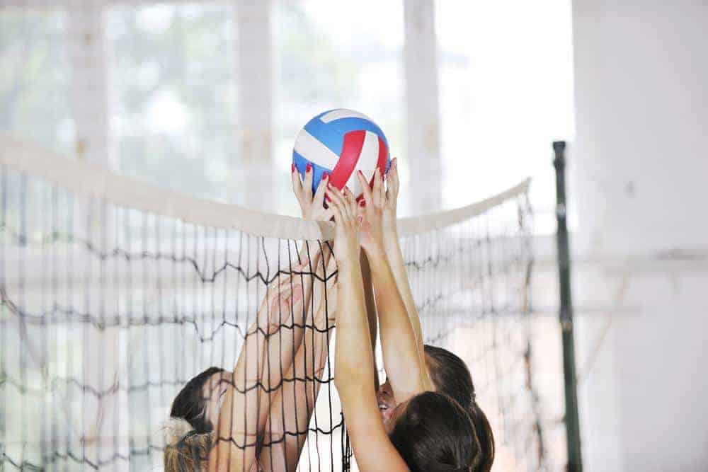 Young women playing volleyball