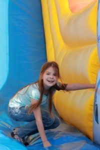 Girl playing in a Bounce House at a birthday party at our Gatlinburg sports complex.