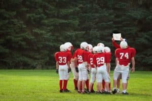 players reviewing Gatlinburg football playbook