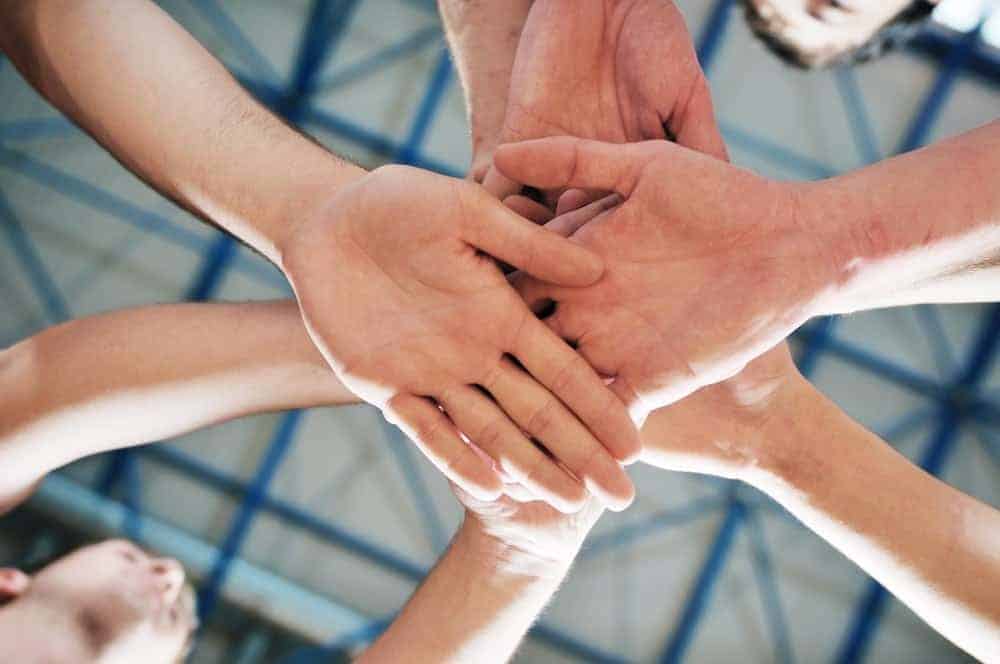 Memebers of a Smoky Mountain sports league put their hands in.