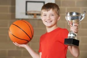 player receiving trophy at Gatlinburg basketball tournaments