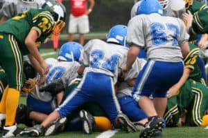 Group tackle in a youth football game.