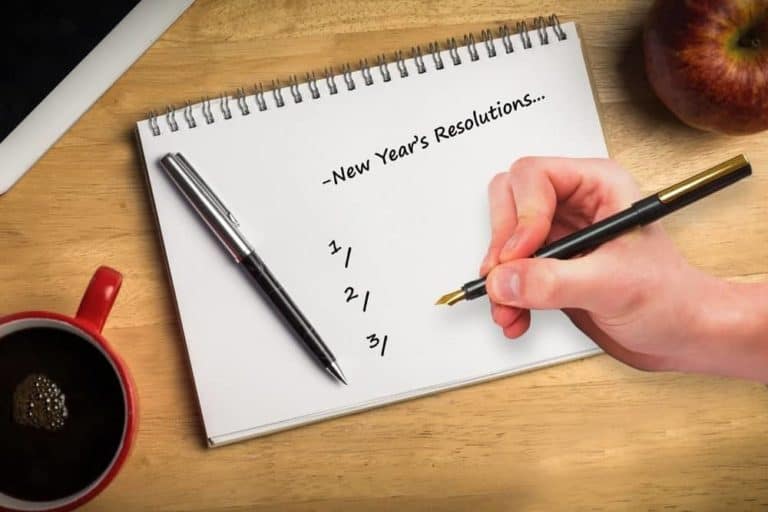 Someone making a list of New Year's Resolutions.
