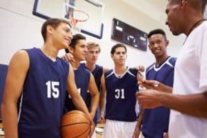 A youth basketball coach giving advice to his team at our Smoky Mountain sports complex.