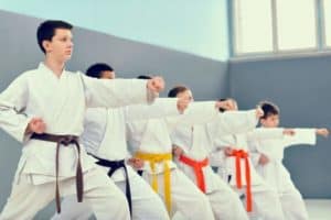 Kids practicing martial arts in a class.