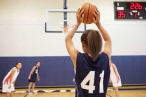 Young women playing basketball.