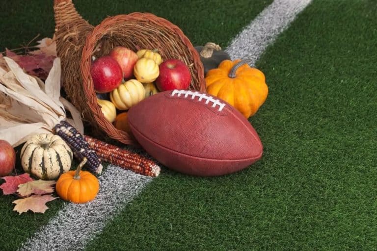 A Thanksgiving cornucopia with a football on the field.