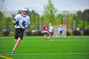 Young men playing lacrosse.