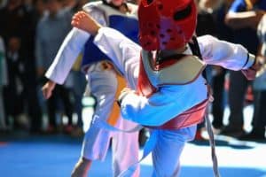 Two boys competing in a taekwondo tournament.