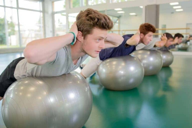 Young athletes training on exercise balls.