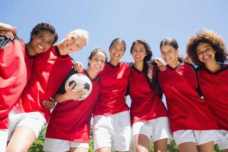 Confident young women on a soccer team.