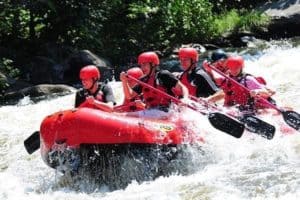 A group of people whitewater rafting with Smoky Mountain Outdoors.