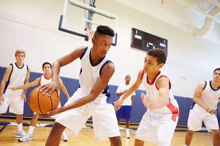 High schoolers playing basketball.