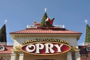 Santa Claus, reindeer, and a Christmas tree on the roof of the Smoky Mountain Opry.
