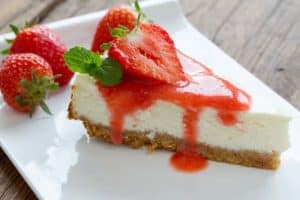 A slice of strawberry cheesecake.