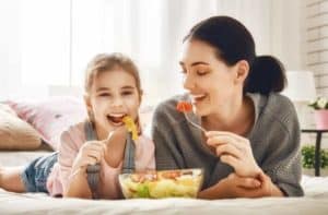 mother and daughter eating a salad