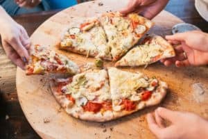 people sharing pizza