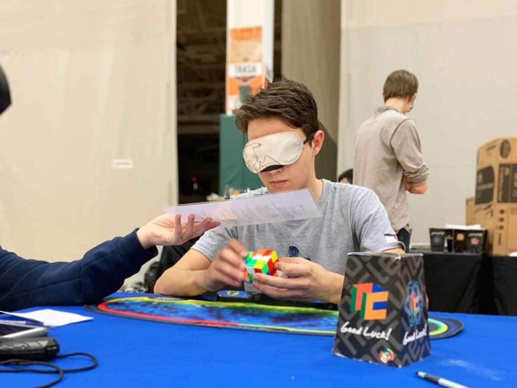 kid playing with a rubix cube