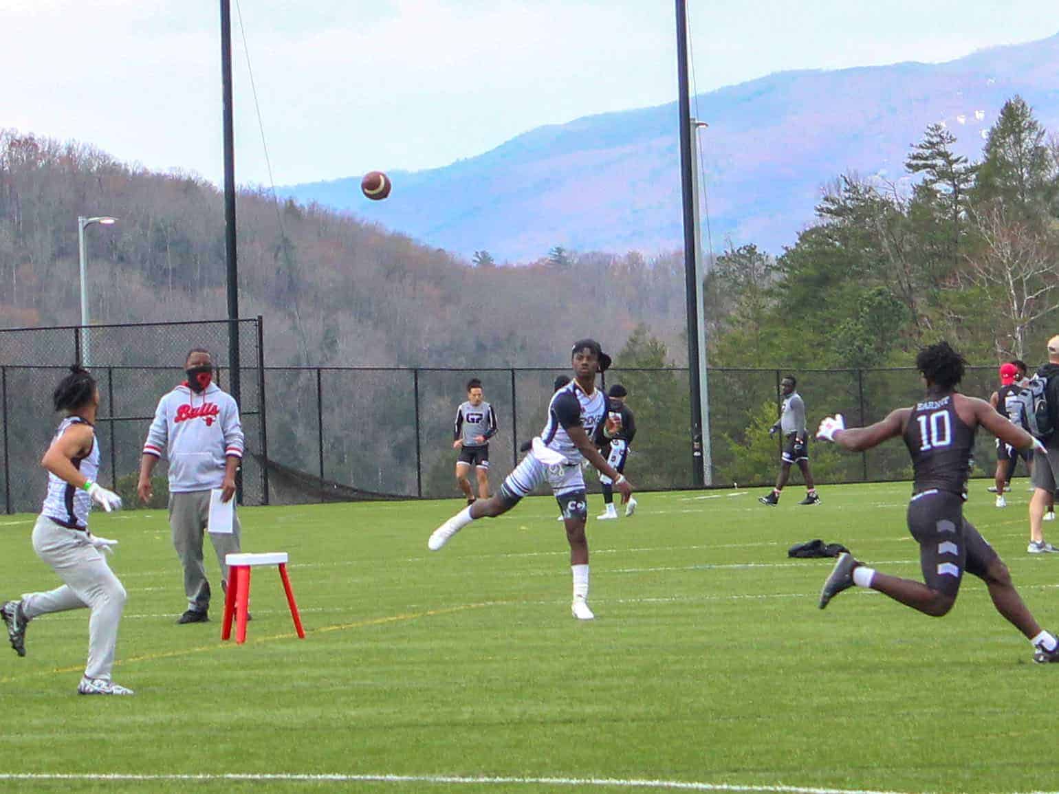 quarterback slinging a football to a receiver downfield
