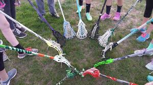 circle of lacrosse sticks on the ground 