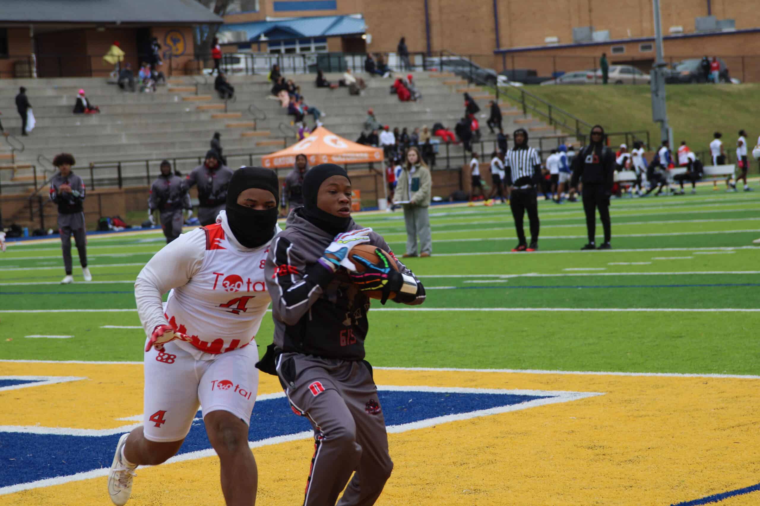 youth football players fighting for a catch in the endzone