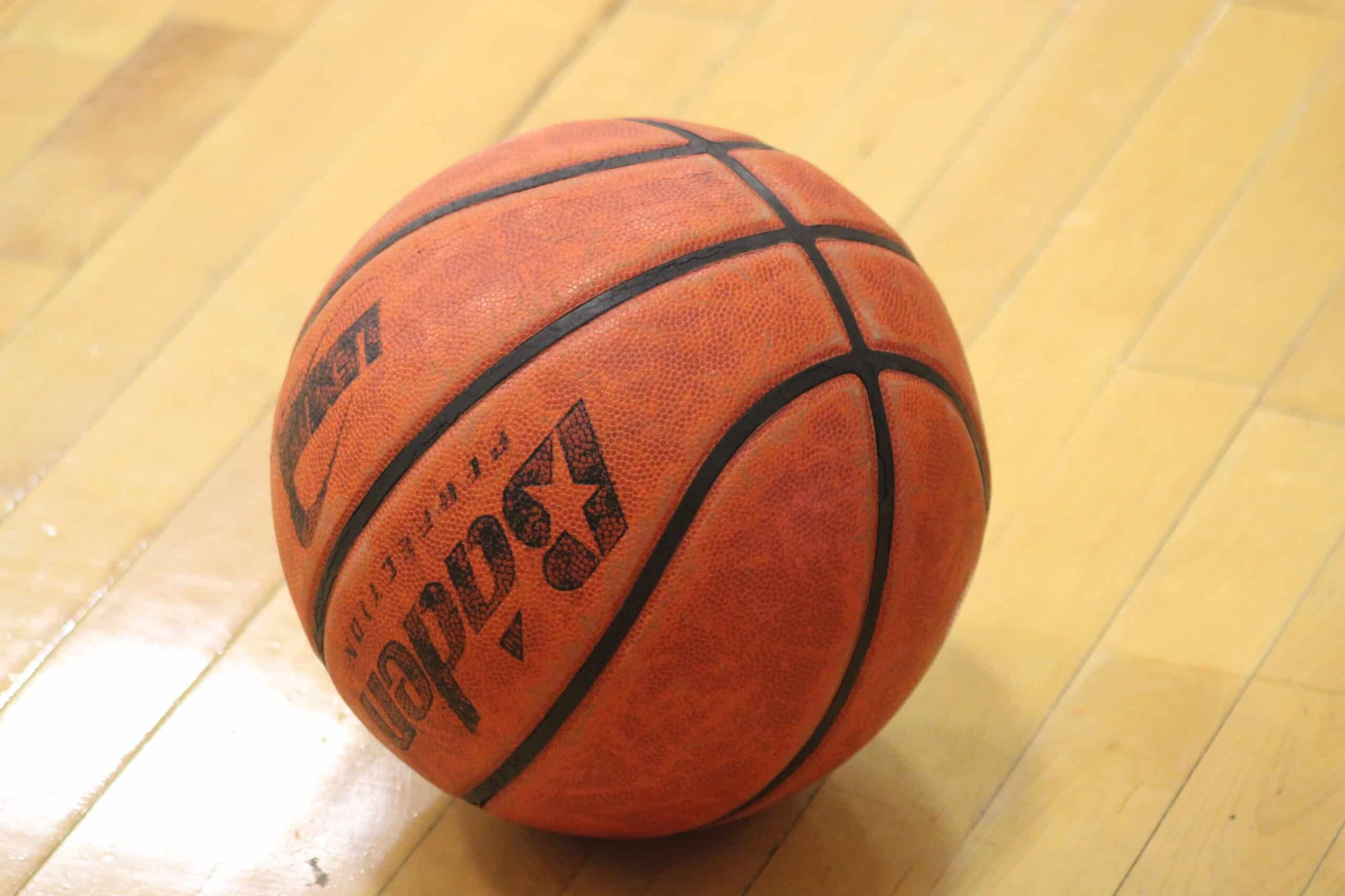 basketball placed on a wooden court