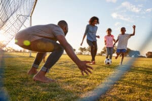 parents play soccer with kids