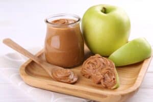 apples and peanut butter on plate